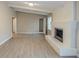 Living room featuring fireplace, gray walls, white ceiling beams and neutral flooring at 5845 Highway 92, Fairburn, GA 30213