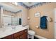 Bathroom featuring a single sink vanity, tiled shower, and decorative wallpaper border at 6844 Cavalier Ct, Stone Mountain, GA 30087