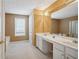 Spacious bathroom with double sinks, white cabinetry, and a large mirror at 6844 Cavalier Ct, Stone Mountain, GA 30087