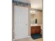 Clean bathroom with a wood vanity, ample counter space, and a framed mirror at 6844 Cavalier Ct, Stone Mountain, GA 30087