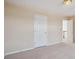 Upstairs bedroom with neutral carpet, lighting, and paint at 6844 Cavalier Ct, Stone Mountain, GA 30087