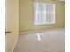 Bright bedroom featuring a window with blinds, neutral paint and carpet flooring at 6844 Cavalier Ct, Stone Mountain, GA 30087