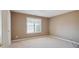 Cozy bedroom featuring neutral paint, a large window and carpet flooring at 6844 Cavalier Ct, Stone Mountain, GA 30087