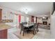 The dining room features a stone table and flows into the living room with a fireplace at 6844 Cavalier Ct, Stone Mountain, GA 30087