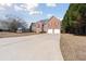 Charming two-story brick home with red shutters and attached two-car garage on a large lot at 6844 Cavalier Ct, Stone Mountain, GA 30087