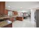 A spacious kitchen featuring granite countertops and stainless steel appliances with a dining area at 6844 Cavalier Ct, Stone Mountain, GA 30087