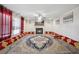 Bright living room with fireplace, large rug, and unique seating arrangement at 6844 Cavalier Ct, Stone Mountain, GA 30087