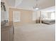 Expansive main bedroom boasting natural light, tray ceilings, and contemporary chandelier at 6844 Cavalier Ct, Stone Mountain, GA 30087