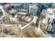 Aerial view of a residential apartment building with nearby shops and city skyline at 1116 Piedmont Ne Ave # 12, Atlanta, GA 30309