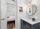 Stylish bathroom features a round mirror, modern vanity, and view into bedroom at 1116 Piedmont Ne Ave # 12, Atlanta, GA 30309