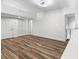Living area featuring wood-look floors, closets, and staircase railing at 1116 Piedmont Ne Ave # 12, Atlanta, GA 30309