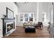 Bright living room with hardwood floors, fireplace, and large windows, creating a welcoming and elegant space at 1116 Piedmont Ne Ave # 12, Atlanta, GA 30309