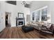 Sunlit living room featuring vaulted ceilings, a fireplace, hardwood floors, and ample seating at 1116 Piedmont Ne Ave # 12, Atlanta, GA 30309