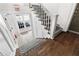 Inviting staircase with hardwood treads, patterned runner, and white painted risers and banister at 1116 Piedmont Ne Ave # 12, Atlanta, GA 30309