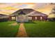 Well-maintained backyard featuring a screened-in porch, lush lawn, and charming pathway leading to the home at 477 Glouchester Dr, Locust Grove, GA 30248