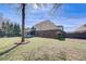 Expansive backyard featuring a screened porch and well-maintained lawn at 477 Glouchester Dr, Locust Grove, GA 30248