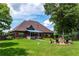 Spacious backyard featuring a covered patio and outdoor seating area at 477 Glouchester Dr, Locust Grove, GA 30248
