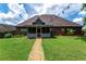 Well-maintained backyard with covered patio and landscaped garden beds at 477 Glouchester Dr, Locust Grove, GA 30248