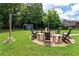 Backyard featuring a fire pit with wooden chairs and an outbuilding at 477 Glouchester Dr, Locust Grove, GA 30248