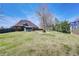 Expansive backyard featuring a well-manicured lawn, mature trees, and a view of the home's exterior at 477 Glouchester Dr, Locust Grove, GA 30248
