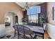 Elegant dining room with a large window, stylish chandelier, and formal dining set at 477 Glouchester Dr, Locust Grove, GA 30248