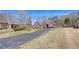 Charming brick home with a long driveway and well-manicured lawn at 477 Glouchester Dr, Locust Grove, GA 30248