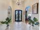 Elegant foyer with arched doorways, tiled floor, and a decorative front door at 477 Glouchester Dr, Locust Grove, GA 30248