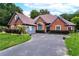 Stunning brick home featuring an attached garage, well-manicured lawn and an inviting driveway at 477 Glouchester Dr, Locust Grove, GA 30248
