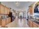 Well-lit kitchen with tile floors, granite countertops, and wood cabinetry at 477 Glouchester Dr, Locust Grove, GA 30248
