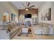 Spacious living room with fireplace, large ceiling fan, and neutral decor at 477 Glouchester Dr, Locust Grove, GA 30248