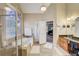 Bathroom with soaking tub, walk-in shower, and double sinks with granite counters at 477 Glouchester Dr, Locust Grove, GA 30248