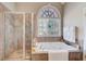 Bathroom features a soaking tub with jets, a separate shower, and a large window at 477 Glouchester Dr, Locust Grove, GA 30248