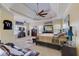 A primary bedroom showcasing a tray ceiling, seating area, and large windows at 477 Glouchester Dr, Locust Grove, GA 30248