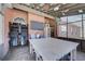 Covered patio with brick accents, a TV, and outdoor seating area for relaxation and entertainment at 477 Glouchester Dr, Locust Grove, GA 30248