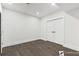 Spacious basement features hardwood floors and white walls at 1857 Defoor Ave, Atlanta, GA 30318