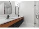 Modern bathroom featuring a double sink vanity, marble accents, and a sleek glass-enclosed shower at 1857 Defoor Ave, Atlanta, GA 30318