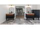 Dual vanity bathroom featuring modern black cabinetry and marble floors leading to closet at 1857 Defoor Ave, Atlanta, GA 30318