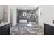 Luxurious bathroom with marble tile, a modern bathtub, and a glass-enclosed shower at 1857 Defoor Ave, Atlanta, GA 30318