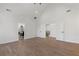 Bright bedroom with hardwood floors and open doors leading to the bathroom and stairs at 1857 Defoor Ave, Atlanta, GA 30318
