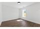Bright bedroom featuring hardwood floors, white walls, and large windows that provide ample natural light at 1857 Defoor Ave, Atlanta, GA 30318