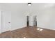 Clean, bright bedroom featuring hardwood floors, white walls, and modern doors for a sleek, minimalist aesthetic at 1857 Defoor Ave, Atlanta, GA 30318