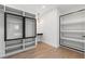 Walk-in closet featuring custom shelving and glass door cabinets at 1857 Defoor Ave, Atlanta, GA 30318