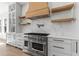 Modern kitchen with stainless steel appliances, marble countertops, and white cabinetry at 1857 Defoor Ave, Atlanta, GA 30318