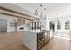Open kitchen with island, stainless steel appliances, and hardwood floors at 1857 Defoor Ave, Atlanta, GA 30318
