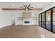 Bright living room with a modern fireplace, exposed beams, hardwood floors, and glass doors at 1857 Defoor Ave, Atlanta, GA 30318