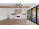 Open-concept living room featuring wood beams, a modern fireplace, and large sliding doors at 1857 Defoor Ave, Atlanta, GA 30318