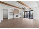 Bright living room featuring wood beams, fireplace, and large sliding doors at 1857 Defoor Ave, Atlanta, GA 30318