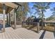 View of a screened porch with dark wood railings overlooking the backyard at 1857 Defoor Ave, Atlanta, GA 30318