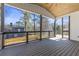 Inviting screened porch featuring a wooden deck and views of the backyard and surrounding trees at 1857 Defoor Ave, Atlanta, GA 30318