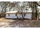 Charming home featuring a white exterior, a metal roof, and a simple entryway surrounded by mature trees at 251 Killian St, Canton, GA 30114